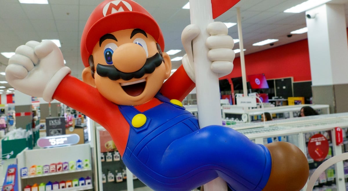 super mario on white poll, blue pants, red top, white man, brown moustache, red hat, big nose