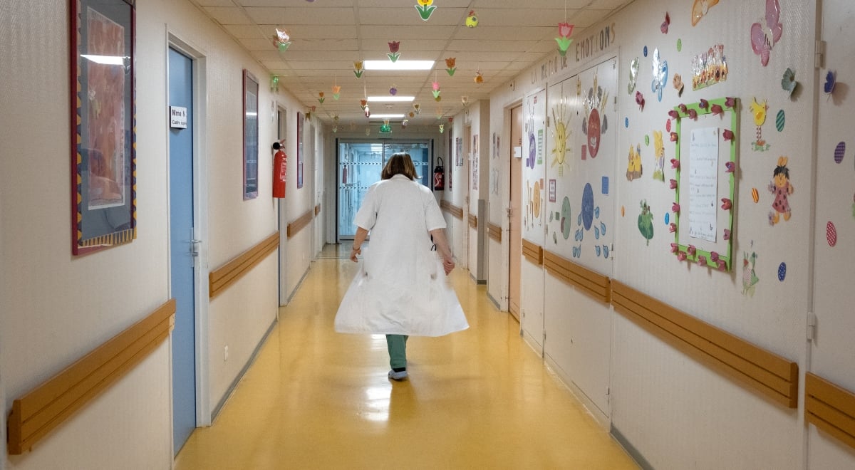 Nurse walking down a hospital corridor