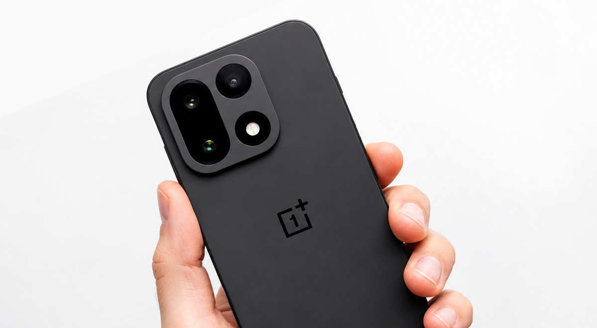 OnePlus 15 smartphone held in hand with a white backdrop