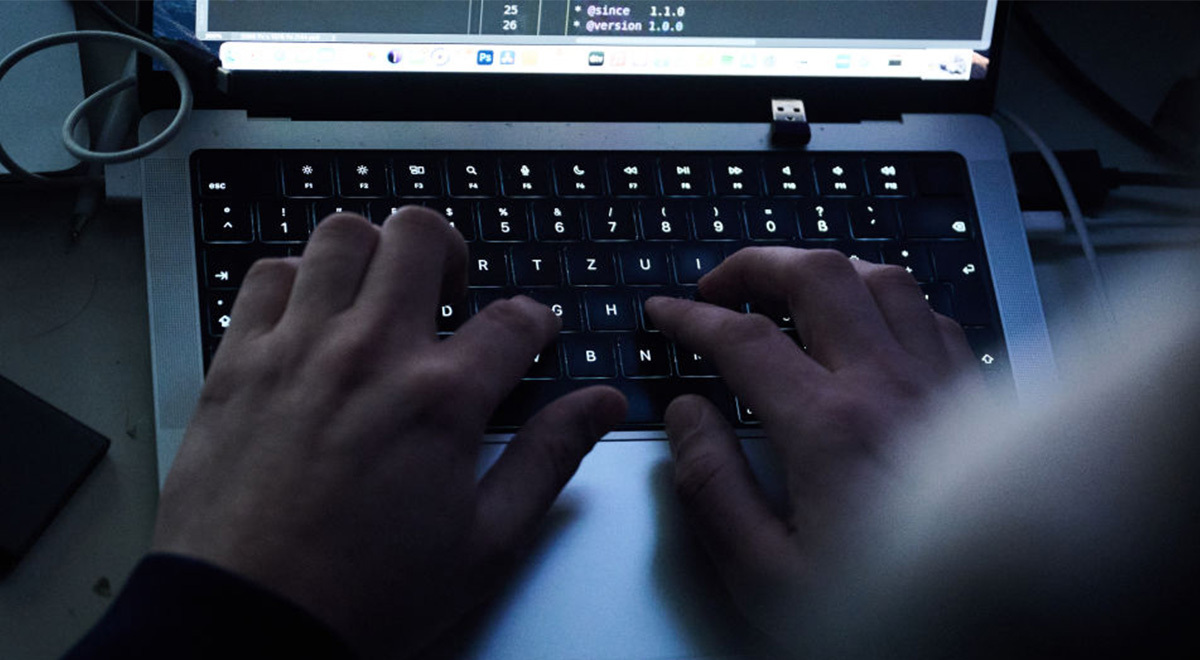 Hands typing on a computer keyboard.