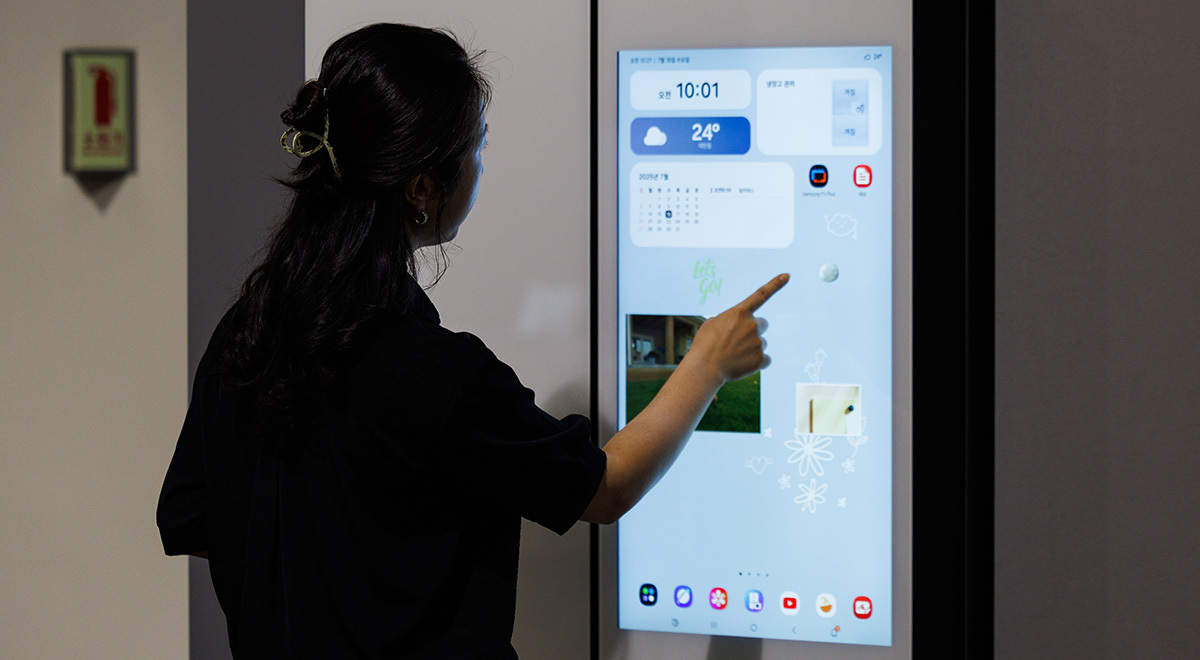 Woman using Samsung smart fridge