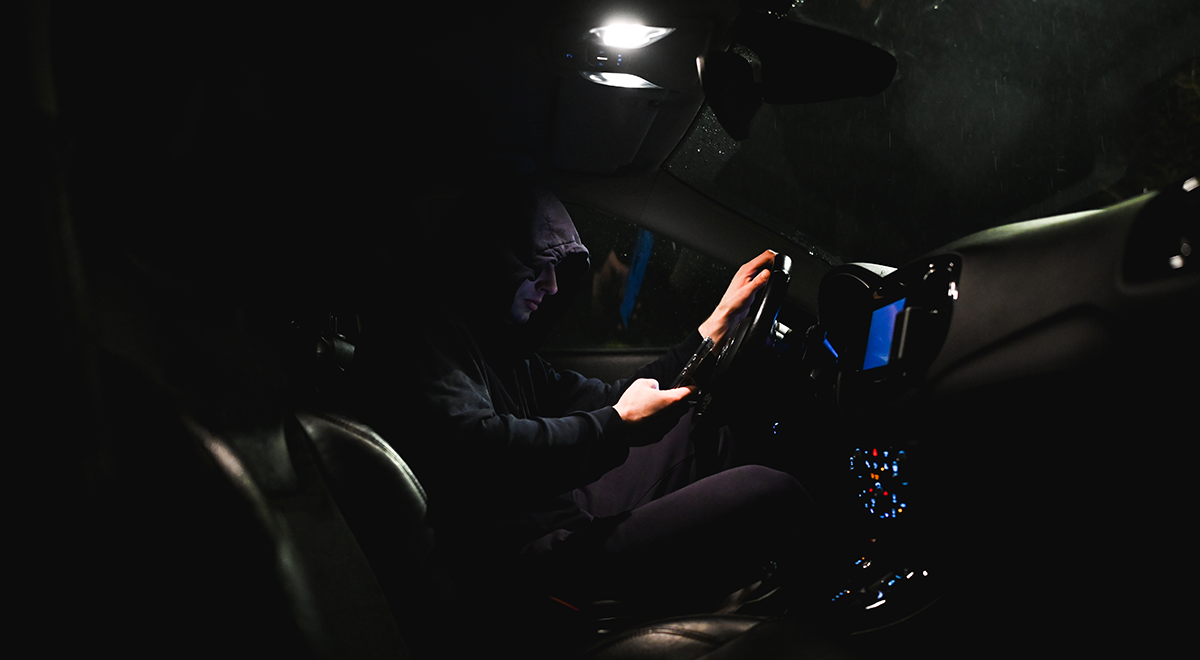 stalker in a car using smartphone