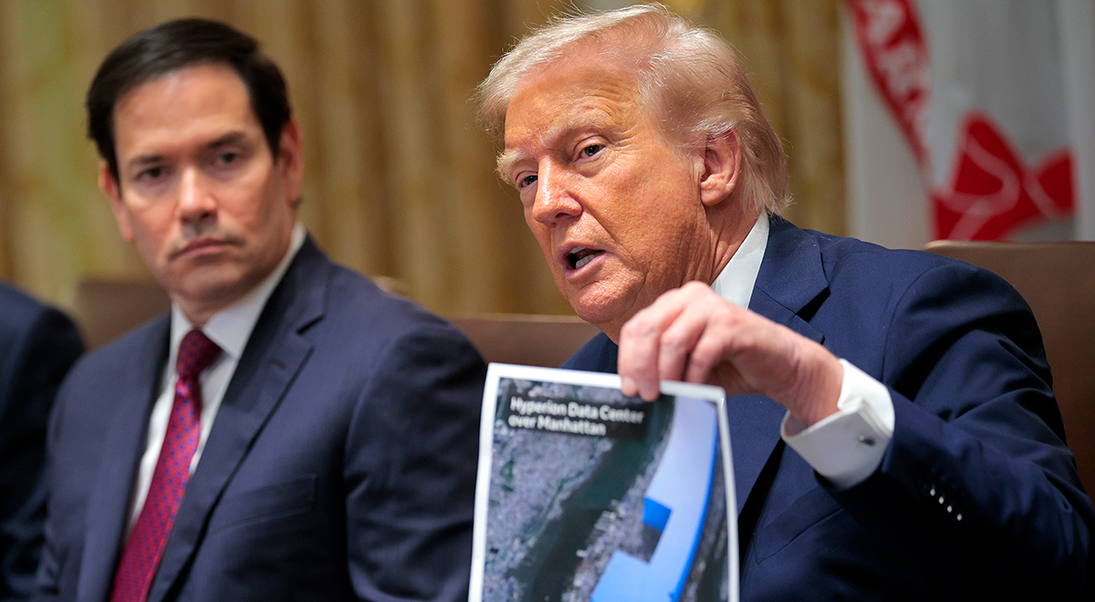 Donald Trump holds up a picture of a data center