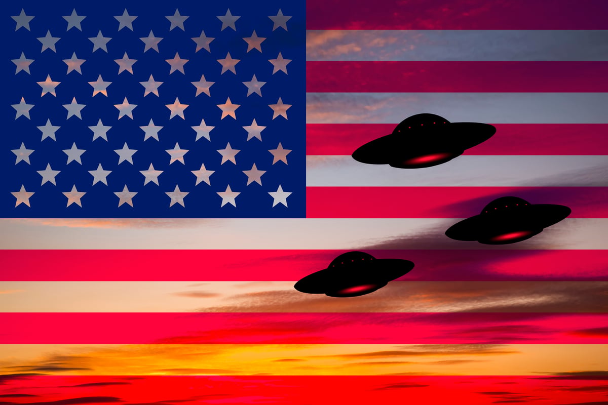 UFOs hovering around the US flag.