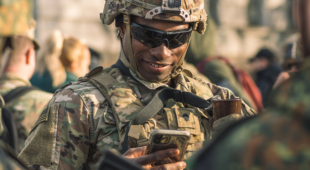 An American soldier holding a smartphone.