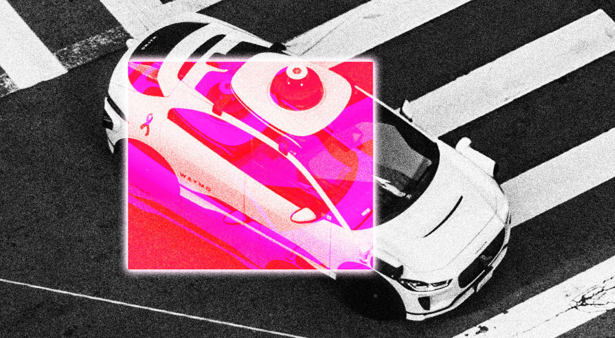 A Waymo autonomous robotaxi in a street.