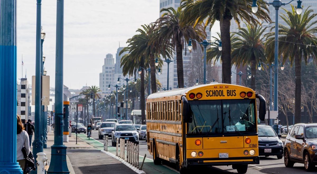 San Diego school bus on city streets with palm trees