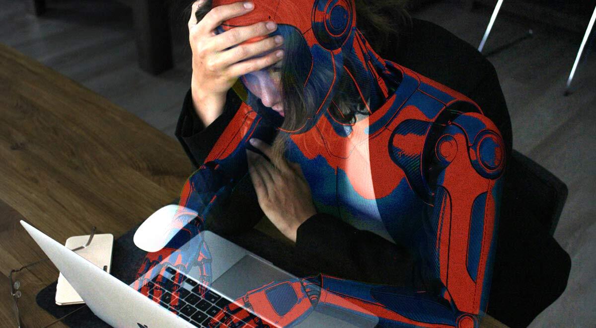 A worried humanoid robot looking at a laptop screen.