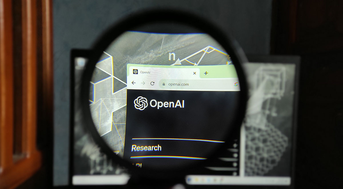 OpenAI logo seen through magnifying glass.