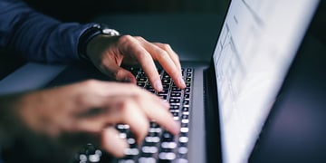 a man typing on a keyboard