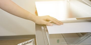 Man copying paper from Photocopier