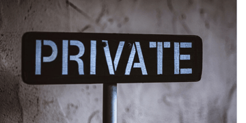 a sign in grey background which says private