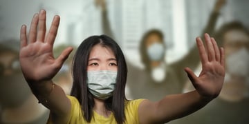 female protesting by holding her hands