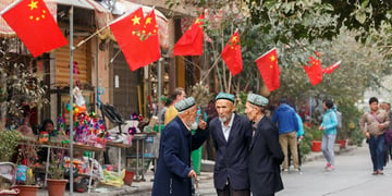 Three men having conversation in Xinhiang