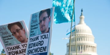 banner with snowden photo in the background of white house