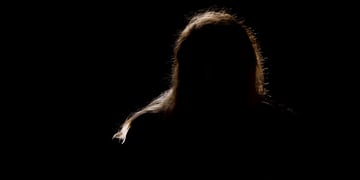 A silhouette of a man in a black background