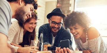 People looking at the phone and laughing