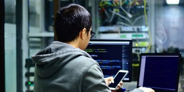 Hacker in front of computers