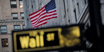 The U.S. flag is seen on a building on Wall St.