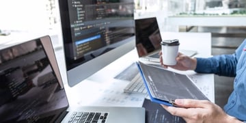 Person in front of multiple computers