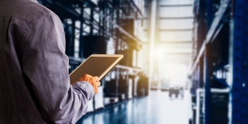 Businessman manager using tablet check and control for workers with Modern Trade warehouse