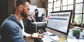 Young man looking at PC screen with Personal Information inscription