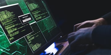Close-up of Caucasian man hands typing data on a keyboard,seen on a computer monitor