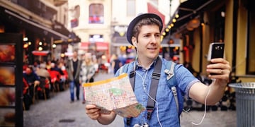 Backpacker Traveler Man traveling alone on crowded streets in old town