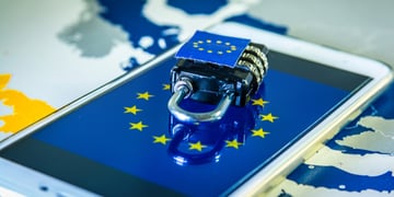 Padlock over a smartphone and EU map