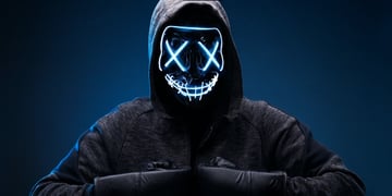 Dangerous hooded hacker in mask and boxing gloves