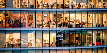 People work in an office building at night