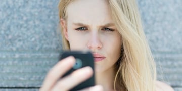 blond woman holding a smartphone
