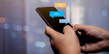 phone with text message bubbles in hands