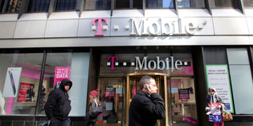 passengers walking by T Mobile shop
