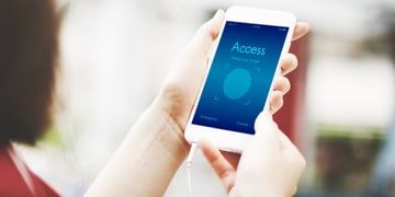 Woman holding phone, digital ID access on screen
