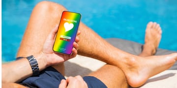 Man using gay and LGBT dating app on his mobile phone