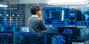Technical operator monitoring activities on multiple displays