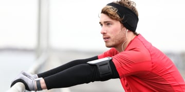 Male runner stretching after running