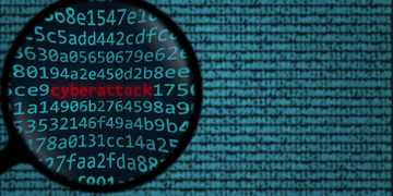 Data through magnifying glass. Ransomware/cyberattack concept