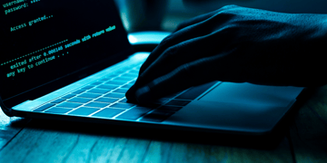 Squirrelwaffle malware concept, hands and a keyboard
