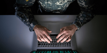 Aerial shot of soldier sitting at computer terminal