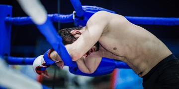 Figurative image of boxer on the ropes, as DeFi protocols get pounded by cybercriminals