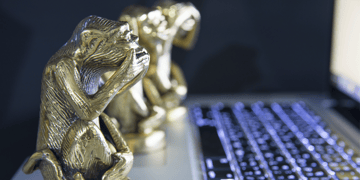 Three monkeys on a computer