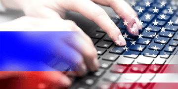 russian and the US flags in front of a keyboard