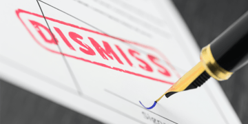 Seal dismiss stamped on a document and fountain pen