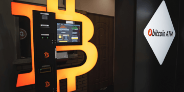 Random user accessing Bitcoin ATM with cellphone
