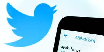 Twitter logo and fake news hashtag