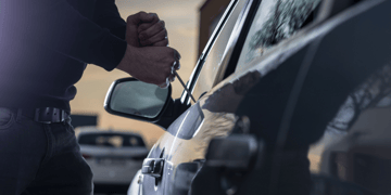 Car thief jemmying door of car