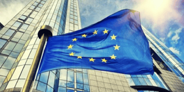 Looming building with EU flag in foreground
