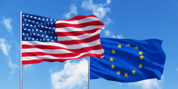 EU and US flags blue sky background